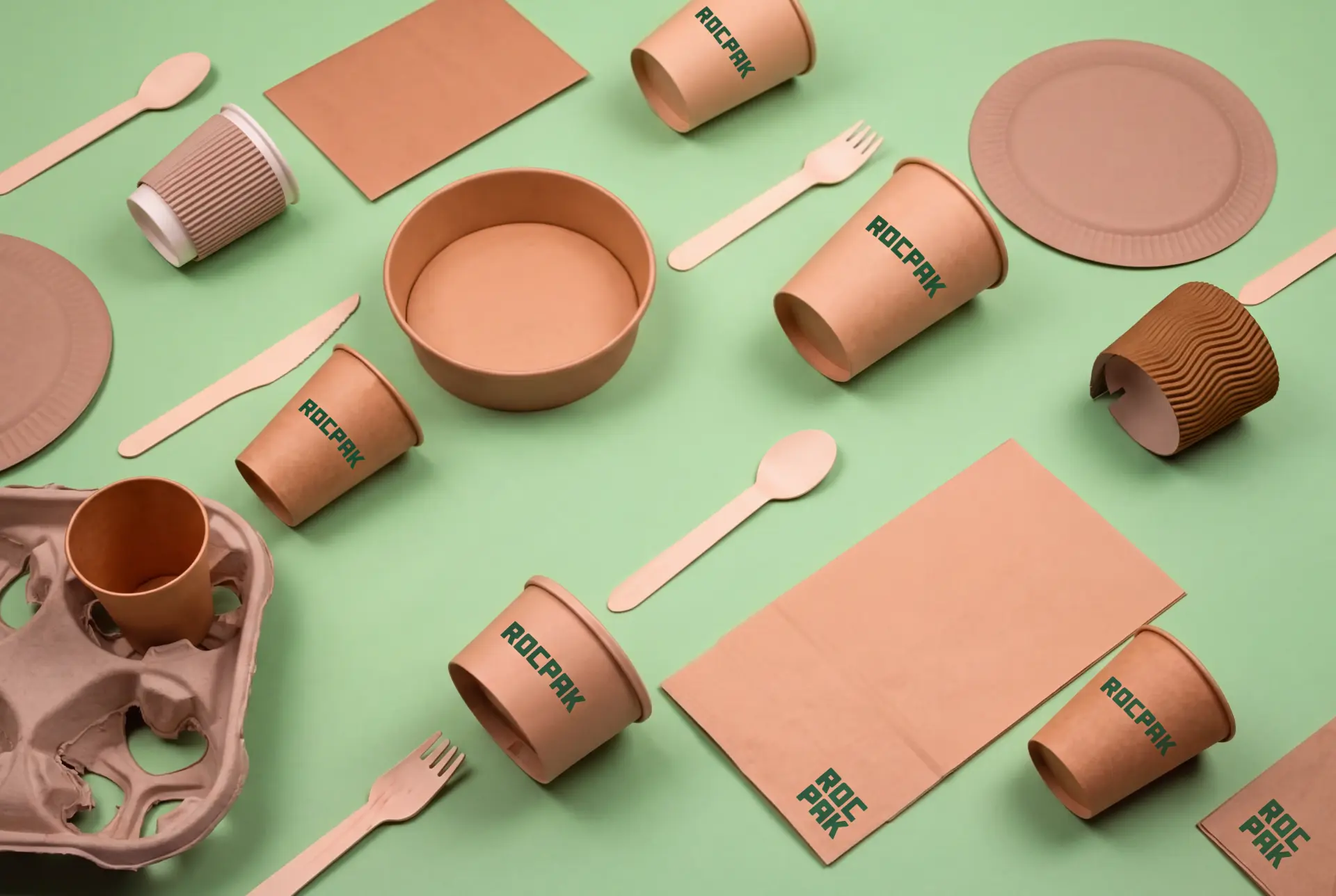 Rocpak branded takeaway packaging range — kraft cups, bowls, plates, bags and wooden cutlery on a green background